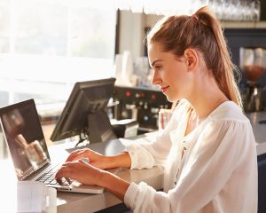 EPoS Software - Female restaurant manager working at counter