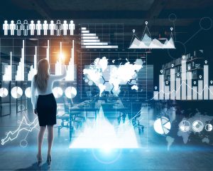 CES EPoS Software - April Newsletter | Hardware Development - Ingenico - Back view of young businesswoman using hi-tech business panel with charts and diagrams in night office. Trading concept
