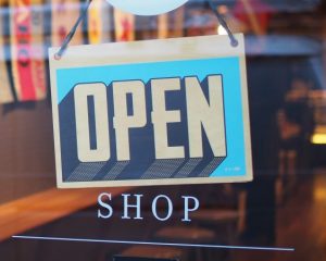 an open sign on a shop front door